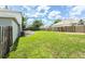 Home's green backyard and a wood fence at 10386 Norvell Rd, Spring Hill, FL 34608