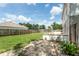 Large backyard featuring a brick patio and a well-maintained lawn at 10386 Norvell Rd, Spring Hill, FL 34608