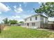 Home's backyard featuring a green lawn and a patio area at 10386 Norvell Rd, Spring Hill, FL 34608