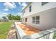 A view of the backyard featuring a home with a patio and a fenced lawn at 10386 Norvell Rd, Spring Hill, FL 34608