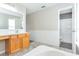 Bathroom boasts a spacious vanity with drawers, a large mirror and a separate shower at 10386 Norvell Rd, Spring Hill, FL 34608