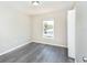 Bright bedroom featuring a window, closet and grey flooring at 10386 Norvell Rd, Spring Hill, FL 34608