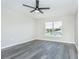 Bedroom featuring a window, ceiling fan and grey flooring at 10386 Norvell Rd, Spring Hill, FL 34608