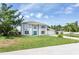 Charming two-story home featuring a bright blue front door and a well-manicured lawn at 10386 Norvell Rd, Spring Hill, FL 34608