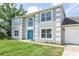 Two-story home with attractive architectural detailing and a well maintained green lawn at 10386 Norvell Rd, Spring Hill, FL 34608