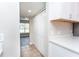 Kitchen area featuring white cabinets and countertops, with an entrance to the living space at 10386 Norvell Rd, Spring Hill, FL 34608