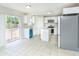 Modern kitchen featuring stainless steel appliances, white cabinetry, and patio access at 10386 Norvell Rd, Spring Hill, FL 34608