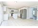 Bright kitchen featuring stainless steel appliances, an island, and a modern white cabinetry at 10386 Norvell Rd, Spring Hill, FL 34608