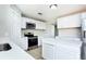 Bright updated kitchen with new appliances, stone countertops, and modern white cabinetry at 10386 Norvell Rd, Spring Hill, FL 34608