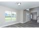 Bright, open living room with large windows and modern flooring. Perfect for entertaining at 10386 Norvell Rd, Spring Hill, FL 34608