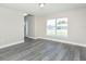 View of the spacious living area with modern flooring and bright natural light at 10386 Norvell Rd, Spring Hill, FL 34608