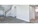 Spacious living area with wood-look flooring, a staircase, and ample closet space at 10386 Norvell Rd, Spring Hill, FL 34608
