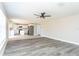 Spacious open-concept living area with updated flooring, flowing into a modern kitchen design at 10386 Norvell Rd, Spring Hill, FL 34608