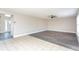 Inviting living room with new floors, light walls, ceiling fan, and a welcoming entryway at 10386 Norvell Rd, Spring Hill, FL 34608