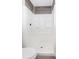 Modern shower with white tile surround and contrasting wood-look accent panel at 10386 Norvell Rd, Spring Hill, FL 34608