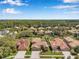 Aerial view of homes with mature trees and landscaping in the area at 11726 Belle Haven Dr, New Port Richey, FL 34654