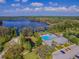 Aerial shot featuring the neighborhood lake, pool, and amenity center at 11726 Belle Haven Dr, New Port Richey, FL 34654