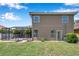 Back exterior of home showcases large screened in patio and well-maintained yard with manicured shrubbery at 11726 Belle Haven Dr, New Port Richey, FL 34654