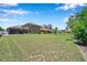 Large backyard with green grass, mature trees and privacy fence at 11726 Belle Haven Dr, New Port Richey, FL 34654