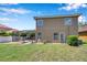 View of the backyard, featuring a well-maintained lawn and screened-in patio at 11726 Belle Haven Dr, New Port Richey, FL 34654