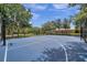Outdoor basketball court with well-maintained surface and fencing, offering opportunities for sports and recreation at 11726 Belle Haven Dr, New Port Richey, FL 34654