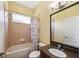 Bathroom with a tub/shower combo, decorative shower curtain, granite vanity, and a large mirror at 11726 Belle Haven Dr, New Port Richey, FL 34654