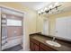 Well-lit bathroom showcasing vanity with sink and a shower-tub combo with neutral tile and updated fixtures at 11726 Belle Haven Dr, New Port Richey, FL 34654