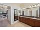 Large bathroom with double vanity sinks and spacious mirror to the left at 11726 Belle Haven Dr, New Port Richey, FL 34654