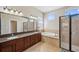 Spacious bathroom with dual sinks, shower and tub, and large windows for natural lighting at 11726 Belle Haven Dr, New Port Richey, FL 34654