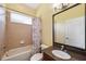 Bathroom with tub/shower combo, granite vanity, and neutral tones at 11726 Belle Haven Dr, New Port Richey, FL 34654