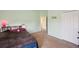 Light green bedroom features a closet and doorway to another room at 11726 Belle Haven Dr, New Port Richey, FL 34654