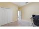 Bedroom featuring neutral walls, carpet, closet, and functional workspace at 11726 Belle Haven Dr, New Port Richey, FL 34654