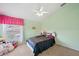 Bedroom featuring light green walls, ceiling fan and plenty of plush decor at 11726 Belle Haven Dr, New Port Richey, FL 34654