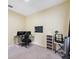 A functional bedroom featuring a desk, computer setup, and neutral tones at 11726 Belle Haven Dr, New Port Richey, FL 34654