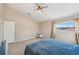 Neutral bedroom featuring a window, ceiling fan and carpet at 11726 Belle Haven Dr, New Port Richey, FL 34654