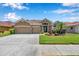Charming home with a two-car garage, beautiful landscaping, and inviting entrance at 11726 Belle Haven Dr, New Port Richey, FL 34654
