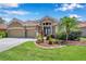 Charming home with a two-car garage, beautiful landscaping, and inviting entrance at 11726 Belle Haven Dr, New Port Richey, FL 34654