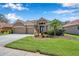 Charming home with a two-car garage, beautiful landscaping, and inviting entrance at 11726 Belle Haven Dr, New Port Richey, FL 34654