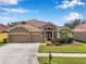 Stunning home featuring a three-car garage and elegant landscaping at 11726 Belle Haven Dr, New Port Richey, FL 34654