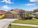 Beautiful home with a three-car garage, manicured lawn, and lush landscaping at 11726 Belle Haven Dr, New Port Richey, FL 34654