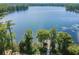 Panoramic aerial view showcases the calm lake and long dock at 11726 Belle Haven Dr, New Port Richey, FL 34654