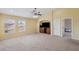 Living room featuring light yellow walls, a ceiling fan and carpet at 11726 Belle Haven Dr, New Port Richey, FL 34654