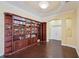 Spacious living room showcasing hardwood floors and custom built-in bookshelves at 11726 Belle Haven Dr, New Port Richey, FL 34654