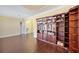 Open-concept living room featuring hardwood floors and a large, built-in bookcase at 11726 Belle Haven Dr, New Port Richey, FL 34654