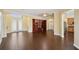 Bright and spacious living room featuring beautiful tile floors, a bookcase and double glass doors at 11726 Belle Haven Dr, New Port Richey, FL 34654