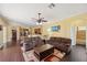 Spacious living room featuring hardwood floors, ceiling fan, and adjacent kitchen area at 11726 Belle Haven Dr, New Port Richey, FL 34654