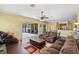 Bright, open living room featuring hardwood floors and large sliding glass doors to the outside patio at 11726 Belle Haven Dr, New Port Richey, FL 34654