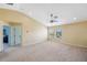 Bright and spacious loft area with neutral walls and carpet, offering versatile living space at 11726 Belle Haven Dr, New Port Richey, FL 34654
