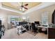 Large office with multiple computer setups and sliding doors to screened in patio at 11726 Belle Haven Dr, New Port Richey, FL 34654