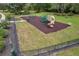 Community playground with slides and swings surrounded by green space, providing a safe play area at 11726 Belle Haven Dr, New Port Richey, FL 34654